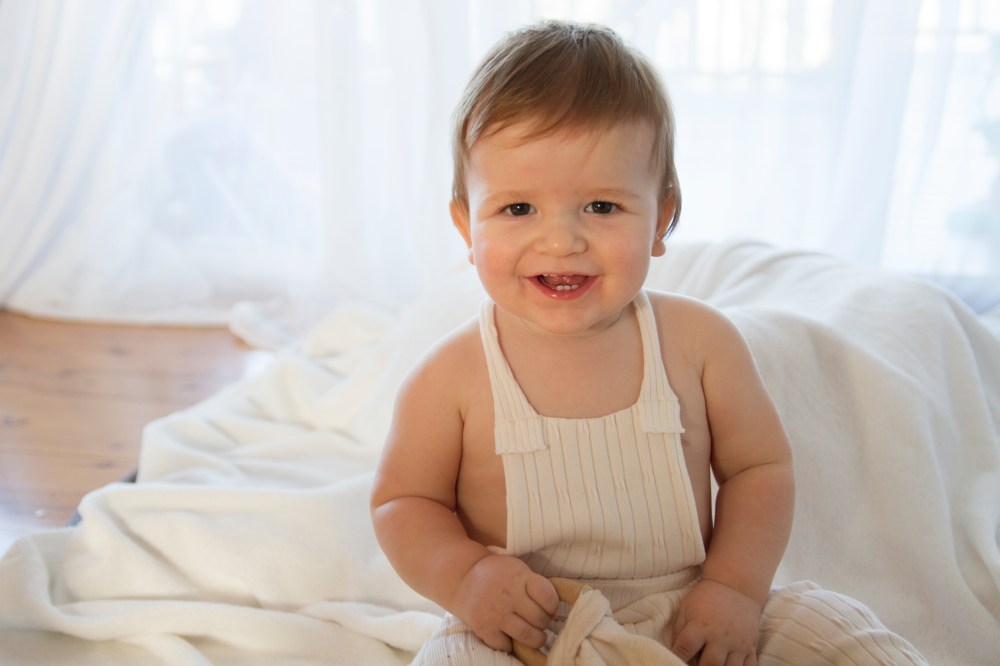 baby photography. Photo of a smiling baby boy in a backlit studio photo