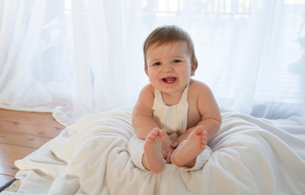 baby photography. smiling baby boy in photo studio. Backlit natural light studio