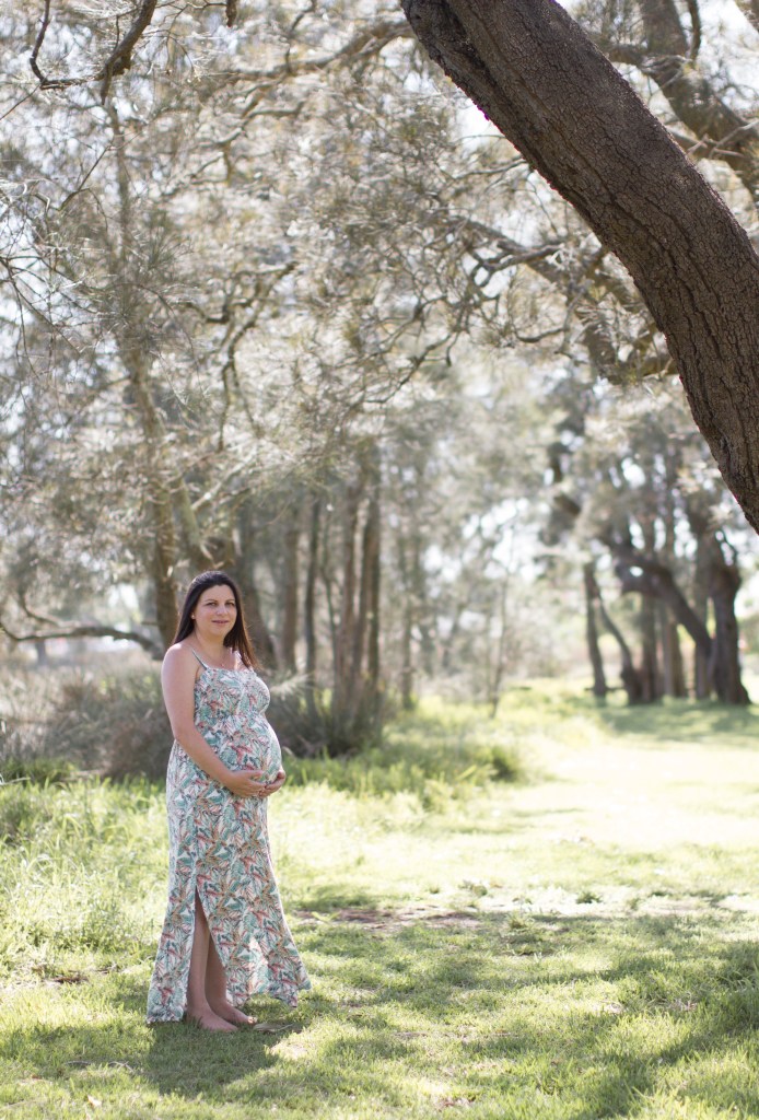 Maternity photograph. Mum to be shot on location beneath trees.