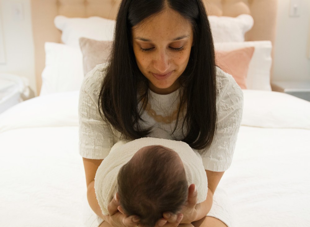 Close up of mother holding new baby. baby lying in mothers hands. Lifestyle newborn session,